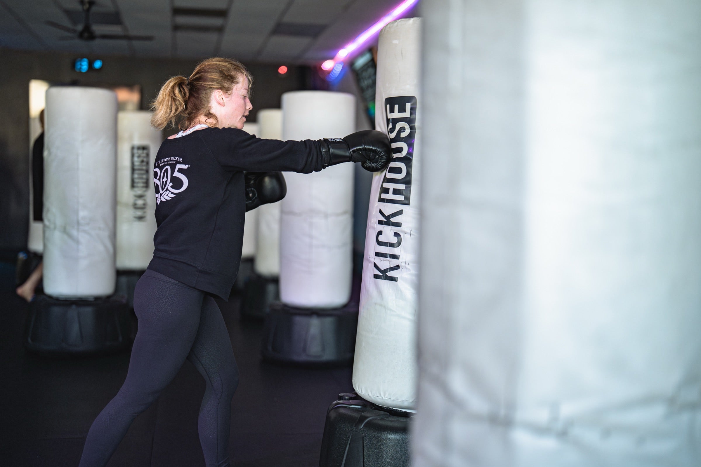 A KickHouse member striking a studio bag